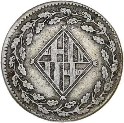 a close up of a silver coin with a design on it