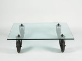 an image of a glass coffee table with wheels on a white background