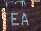 a close up of a piece of cloth with the letters ae on it