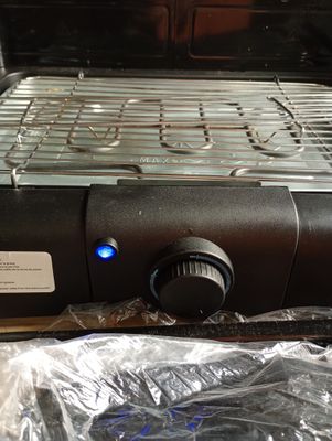 une image représentant un barbecue sur lequel brille une lumière bleue