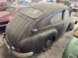an old car that is sitting in a garage