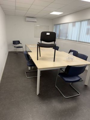 a room with a table and chairs in it