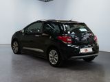 the back of a black car is parked in a showroom