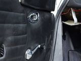 a dog sitting in the door of a car looking out the window