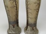 two vases that are sitting on a white surface
