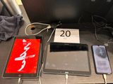 several electronic devices are sitting on a table next to a phone