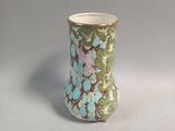 a vase with a floral design on it on a table