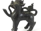 a black statue of a cat with a bird on it ' s back