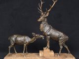 bronze sculpture of a stag and a baby deer on a marble base