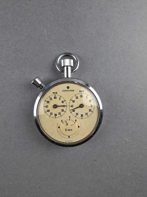 a close up of a stopwatch on a gray surface