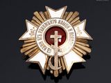 an image of a badge with a cross on it on a black surface