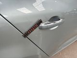 a sticker on the door handle of a car