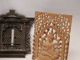 three pieces of carved wood sit next to each other on a white surface