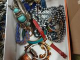 a box full of assorted jewelry on a table