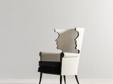 a black and white chair with a mirror on the back of it