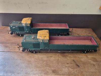 two toy trains that are sitting on a wooden table