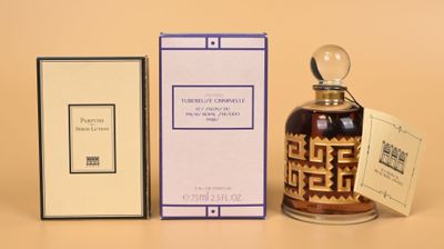 an image of a bottle of perfume next to a box of perfume