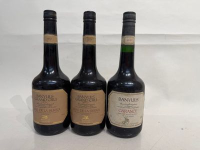three bottles of wine sitting on top of a white table