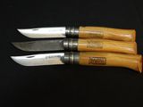three knives that are sitting on a black surface