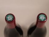 two bottles of wine sitting next to each other on a table