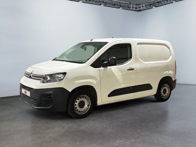 the white van is parked in the empty room of the building
