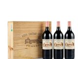three bottles of wine in front of a wooden box