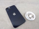 a black iphone sitting next to a white charger