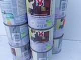 several cans of paint are stacked on top of each other