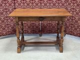 a small wooden table with a drawer underneath it
