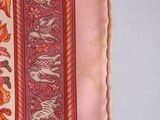 a close up of a pink and red striped pillow