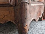 a bed with a wooden headboard and foot board on the floor
