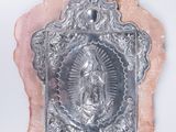 an image of a silver plate with an image of the virgin on it