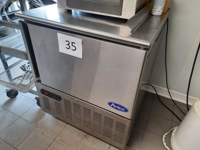 a microwave sitting on top of a refrigerator in a kitchen