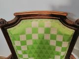 green and white checkered upholstered chair in a corner of a room
