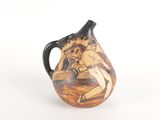 a small vase with a painting on it on a white surface