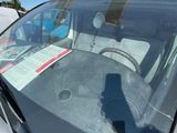 a car that has a sticker on it ' s windshield