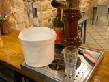 pots and pans sit on a kitchen counter with a stone wall