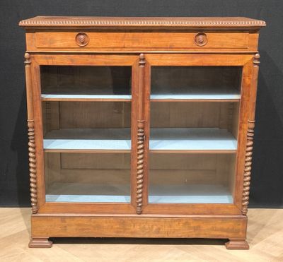 an old wooden display cabinet with glass doors and shelves