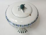 a white bowl with a turtle on it on a table