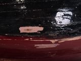 a close up of a red boat with a black hull