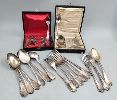 a lot of silver spoons and spoons in a case