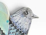 a bird that is sitting on top of a piece of metal