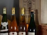 several bottles of wine are lined up on a shelf in a wine cellar