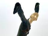 a figurine of a woman with a glove on her hand