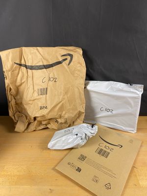 a brown bag sitting on top of a wooden table next to a blackboard