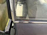 a black car with the door open and the seat up