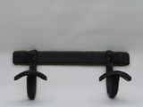 pair of black leather wall hooks on a white background
