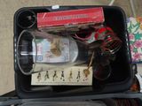 a plastic container with a bottle of wine and other items in it
