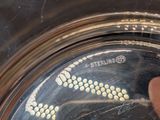 a close up of a person ' s finger on a silver plate