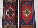 pair of oriental rugs on a tiled floor in a room